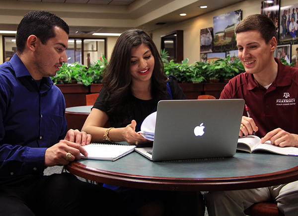 three students studying together